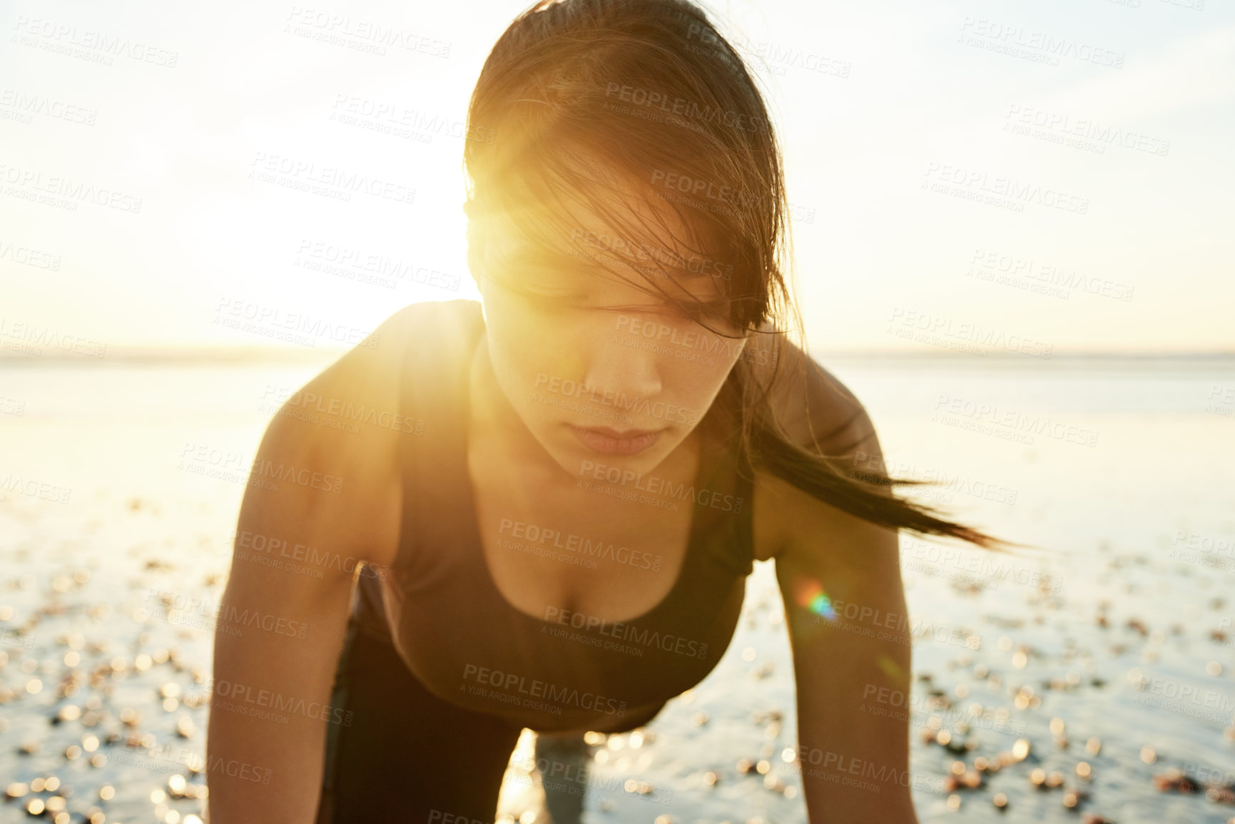 Buy stock photo Fitness, sunshine and woman on beach with push up, sunrise and commitment to healthy outdoor workout. Muscle, training and serious girl at ocean for morning exercise, wellness and body care in nature