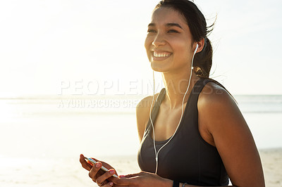 Buy stock photo Woman, phone or thinking on beach for fitness, streaming service or favorite exercise song. Happy athlete, mobile or earphones at ocean for podcast, workout playlist or wellness tracking app progress