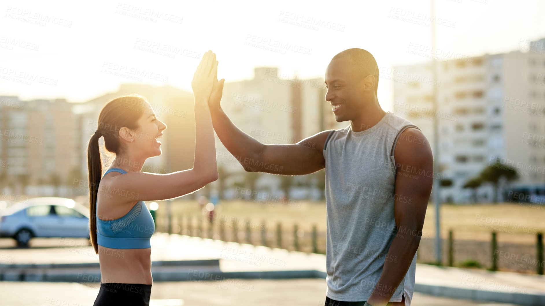 Buy stock photo High five, interracial couple and city sunset for exercise, wellness or endurance workout. Athlete, man and woman with training challenge for fitness, physical health or resilience or cardio together