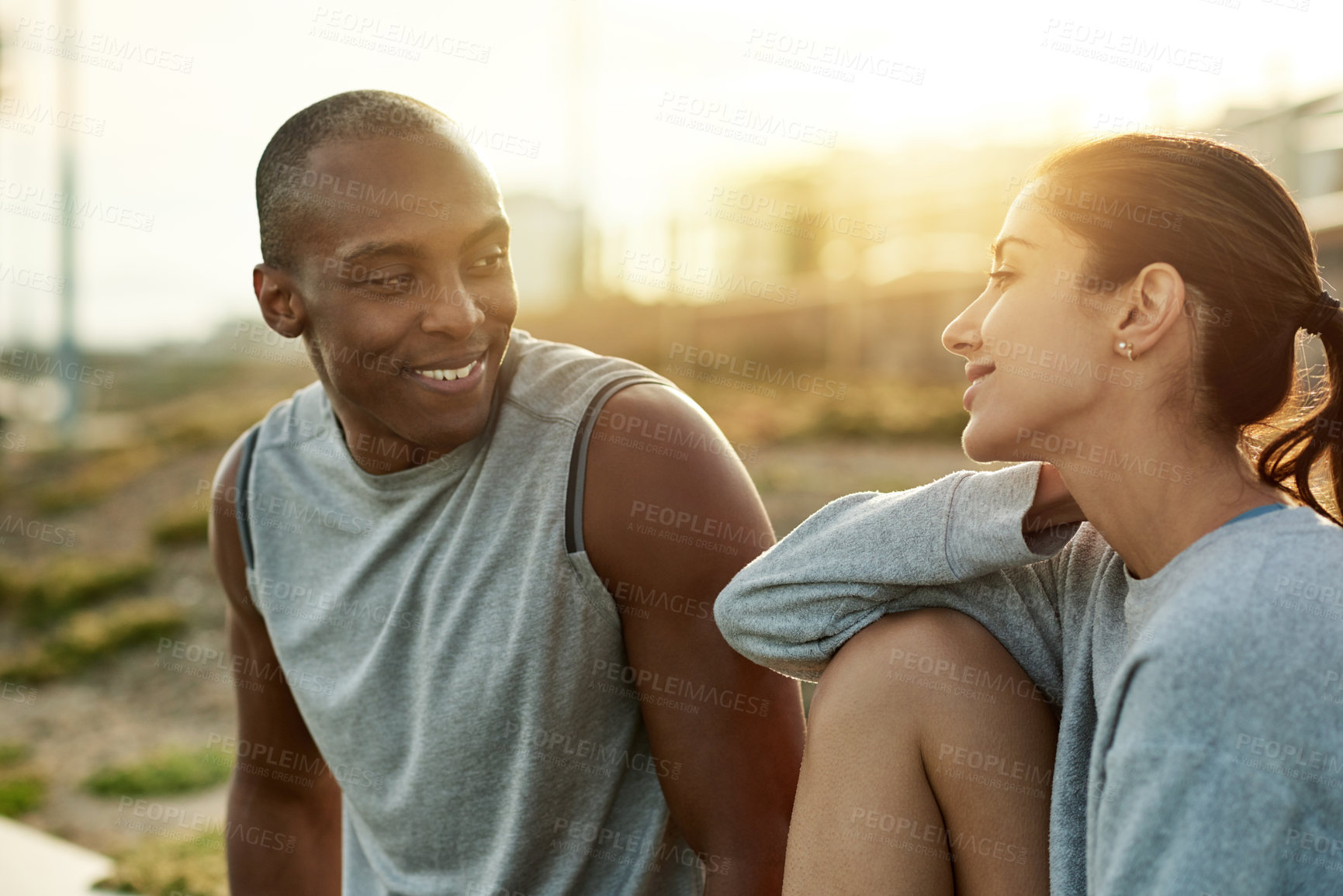 Buy stock photo Outdoor, couple and happy with break for fitness, wellness and bonding with connection for exercise. City, woman and man with support for training rest, conversation and healthy relationship by flare