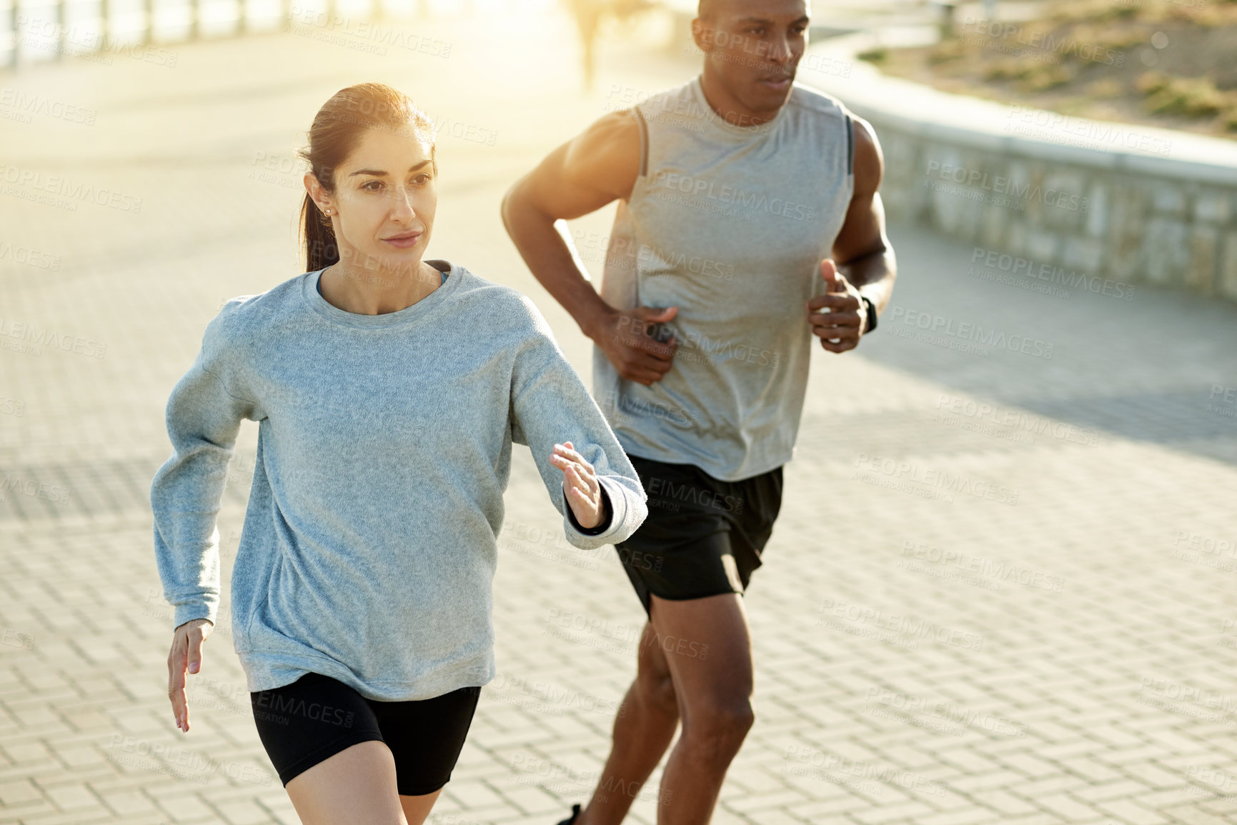 Buy stock photo Fitness, couple and running outdoor for health, body wellness or training by promenade. Interracial, man and woman with cardio exercise for workout, sport or race with energy for endurance marathon