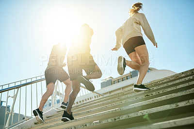Buy stock photo Fitness, group and running in city for exercise, body wellness or friends training with coach in low angle. Team, cardio and people workout outdoor on steps for health, sport and race with energy