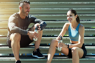 Buy stock photo Talking, fitness and couple on break, steps and happy for exercise in morning, summer and healthy. Outdoor, rest and people with sportswear for workout, training and smile with routine for wellness