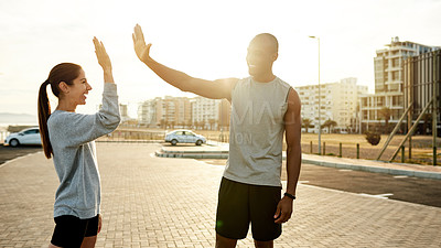 Buy stock photo High five, man and woman in urban city for exercise, motivation and endurance workout. Athlete, interracial couple and training challenge for fitness, physical health and resilience or cardio success