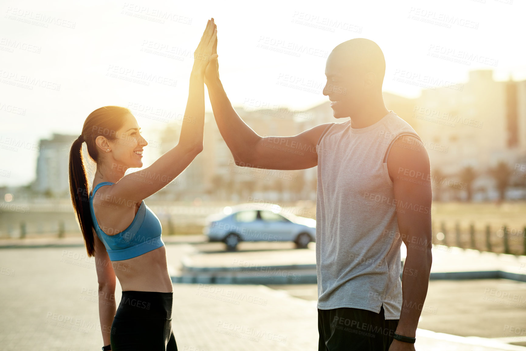 Buy stock photo High five, interracial couple and city sunset for fitness, wellness or workout support. Athlete, man and woman with training goal for exercise, physical health or motivation for cardio together