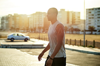 Buy stock photo Black man, fitness or walking exercise in city for running, workout or cardio training in parking lot. Challenge, athlete or runner on break in practice for health, wellness and sports performance
