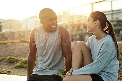 Buy stock photo Outdoor, couple and break with laugh for fitness, wellness and bonding with smile for exercise. City, woman and man with support for training rest, conversation and healthy relationship by flare