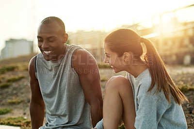 Buy stock photo Outdoor, couple and fitness with talking for break, wellness and bonding with laugh for exercise. City, woman and man with support for training rest, conversation and healthy relationship by flare
