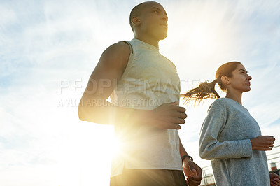 Buy stock photo Couple, team and outdoor for running fitness, workout collaboration and sports support. People, sun flare and training for marathon together on promenade, cardio challenge and athletes exercise