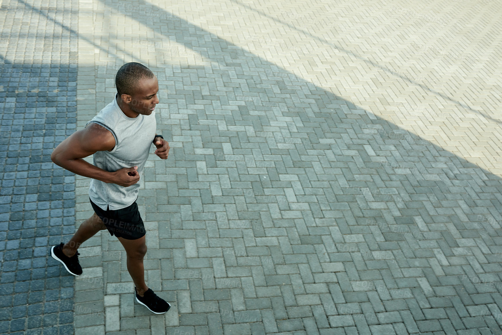 Buy stock photo Black man, outdoor and running fitness in city, workout space and sports in urban town. Male person, top view and training for marathon competition with cardio challenge and athletes exercise
