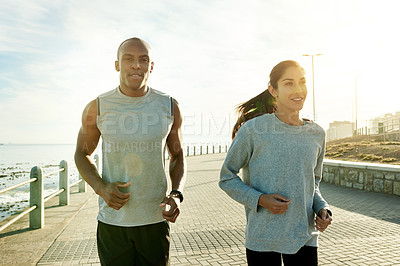 Buy stock photo Fitness, interracial couple and running outdoor for training, body wellness or health at promenade. Team, man and woman with cardio exercise for workout, sport or race with energy for marathon by sea