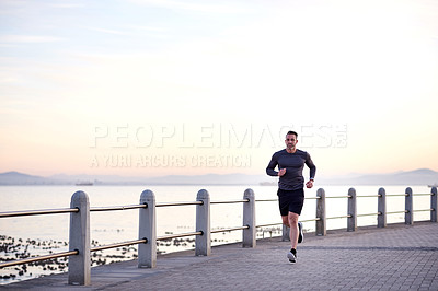 Buy stock photo Beach, running and man with fitness, energy and wellness with workout, practice and routine. Person, athlete and runner with performance, exercise and sports with body health, challenge and ocean
