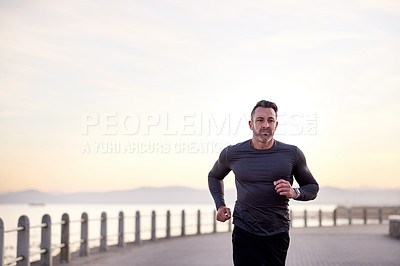 Buy stock photo Beach, running and man with cardio, exercise and wellness with workout, energy and routine. Person, athlete and runner with endurance, fitness and training with body health, challenge and practice