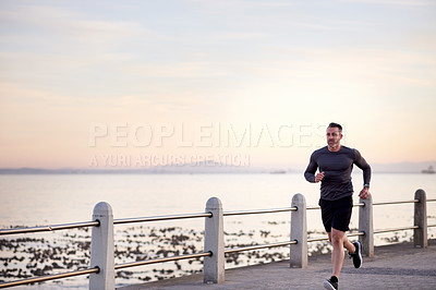 Buy stock photo Beach, running and man with training, morning and wellness with workout, energy and endurance. Person, athlete and runner with performance, exercise and cardio with body health, challenge and fitness