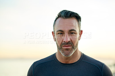 Buy stock photo Portrait, running and man in morning by ocean for exercise, marathon training and cardio workout. Sports, promenade and person for wellness, health and recovery for performance, endurance and fitness