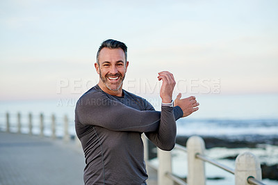 Buy stock photo Portrait, mature man and stretching by beach for marathon preparation, getting ready and muscle strength. Space, arms warm up and training at promenade for wellness challenge and exercise performance