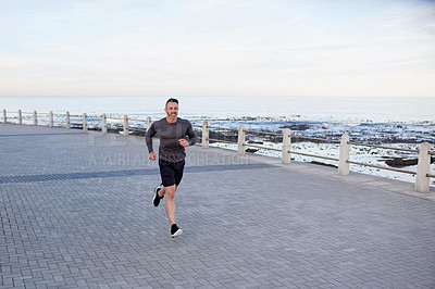 Buy stock photo Mature man, running and exercise on beach promenade, sport workout and activity for mobility health. Male person, physical challenge and training for marathon, mockup space and cardiovascular fitness