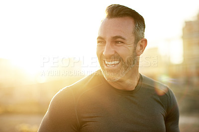 Buy stock photo Happy, running and man in city in morning for exercise, marathon training and cardio workout. Sports, sunshine and person for rest, recovery and health for performance, endurance and fitness outdoors