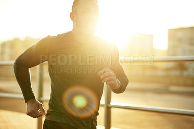 Buy stock photo Man, lens flare and running in city for fitness, cardio exercise and training for marathon in Portugal. Mature athlete, sunset and happy in town for workout routine, physical care or wellness journey