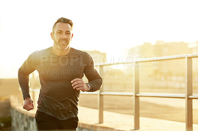 Buy stock photo Man, running and sunset on beach, sports workout and promenade activity for health. Mature male person, physical challenge and training for marathon, outdoor fitness and cardiovascular exercise