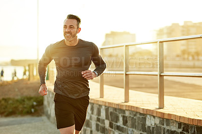 Buy stock photo Mature man, workout and fitness on beach promenade, sports routine and activity for mobility health. Male person, physical challenge and training for marathon, sunset and cardiovascular exercise