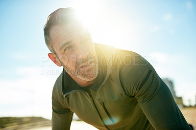 Buy stock photo Tired man, thinking or resting on running break for outdoor exercise, fitness workout or cardio training. Lens flare, face or runner with fatigue in practice for recovery health or sports performance