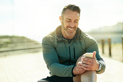 Buy stock photo Man, happy and outdoor with phone for fitness, music and wellness tracking app for care. Mature athlete, mobile and smile in Portugal for streaming service, favorite playlist and warm up tutorial