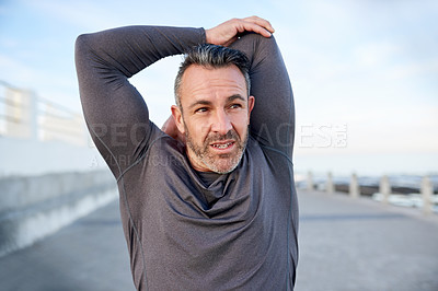 Buy stock photo Fitness, mature man and stretching outdoor for workout preparation, getting ready and muscle relief. Runner, arms warm up and training at promenade for jog, wellness challenge or exercise performance