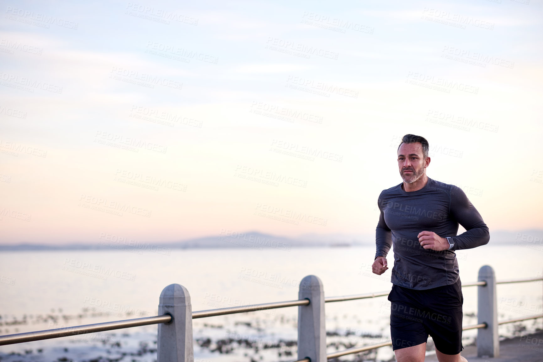 Buy stock photo Beach, running and man with fitness, training and wellness with workout, energy and routine. Person, athlete and runner with performance, exercise and mockup space with health, challenge and practice