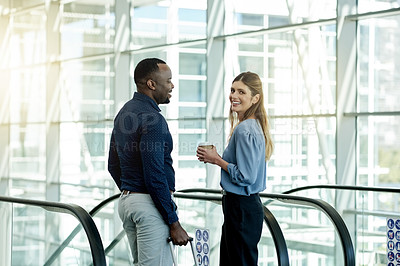 Buy stock photo Escalator, smile and suitcase with business people in airport together for travel or trip. Collaboration, luggage and woman employee talking to man colleague in lobby for international flight