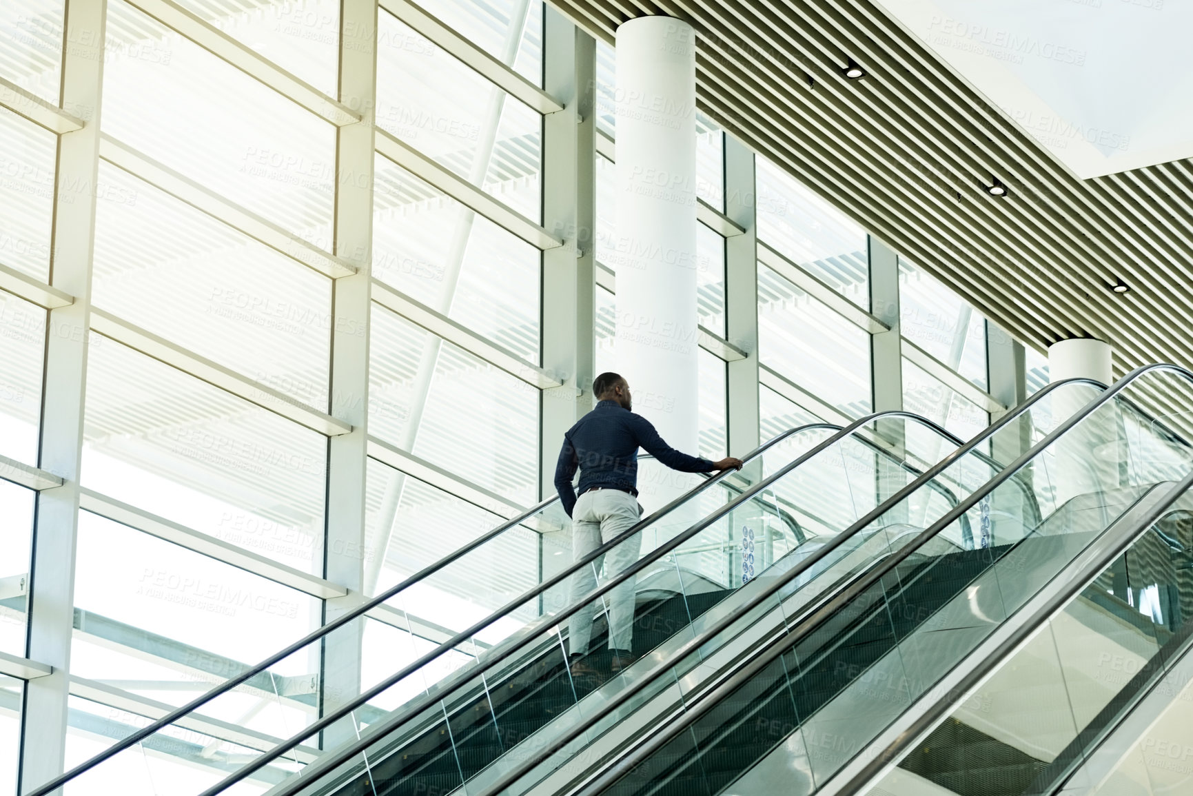 Buy stock photo Escalator, airport and business man for travel, commute and arrive in lobby for international trip. Modern building, professional and person on electric stairs for journey to convention or conference
