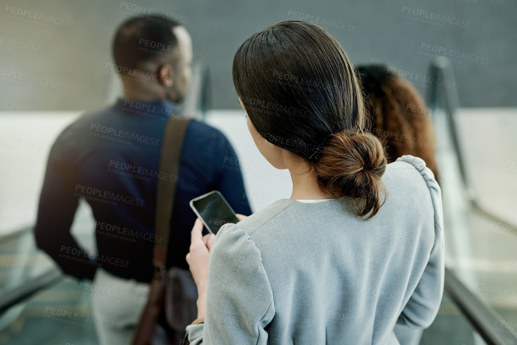 Buy stock photo Escalator, phone and travel with business people in airport from back for communication or trip. Booking, flight schedule and online check in on mobile with employee woman in terminal for departure