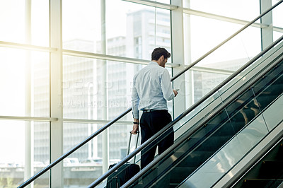 Buy stock photo Escalator, airport and businessman with phone for travel, commute and arrival in lobby for trip. Conference, professional and person on electric stairs on smartphone for schedule and flight info