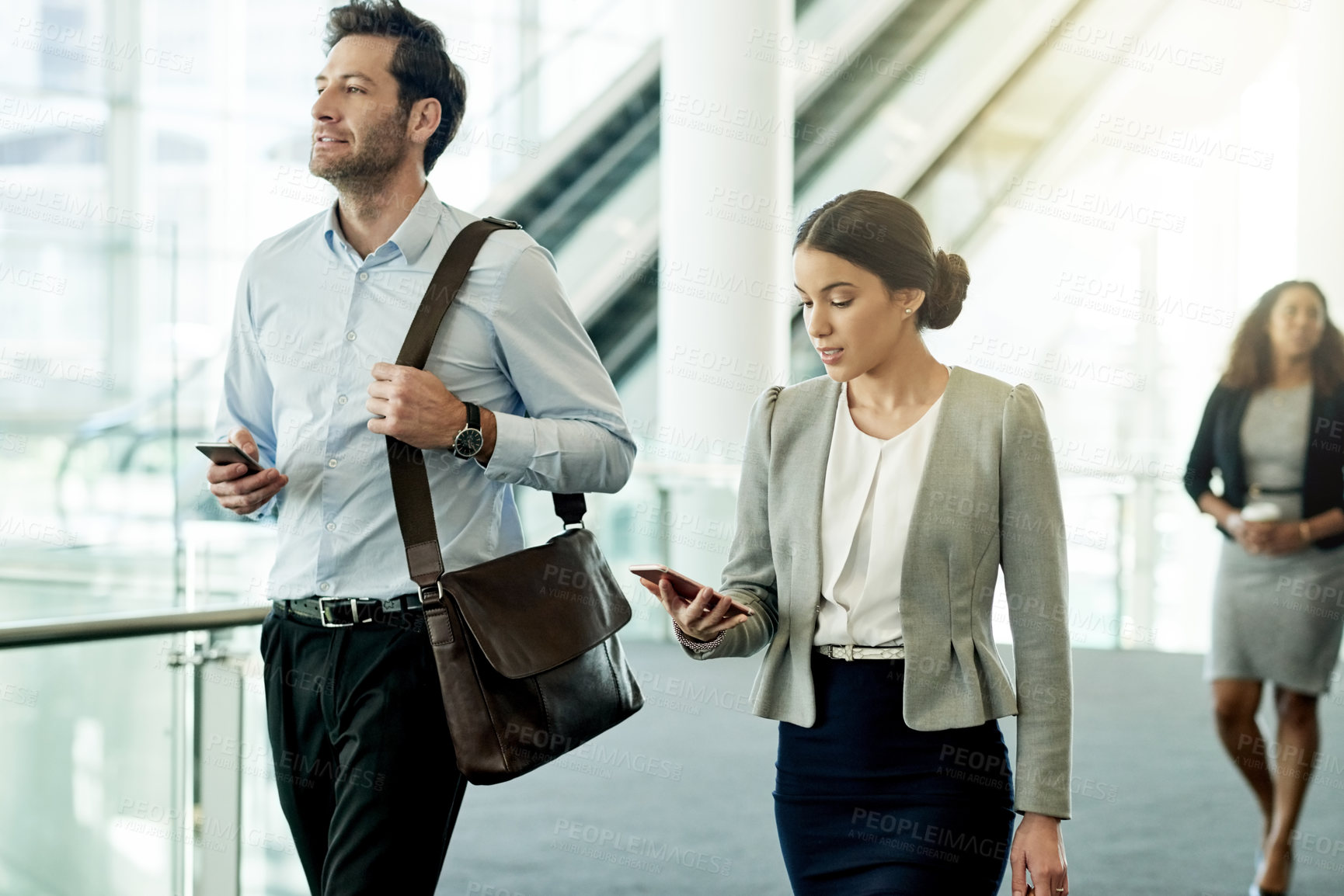 Buy stock photo Business people, walking and start of discussion in office, phone and read morning email for schedule. Employees, company news and online for communication in lobby, networking and workplace travel