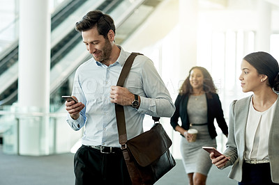 Buy stock photo Business people, walking and start of work in office, phone and reading morning email for schedule. Employees, company news and online for communication in lobby, networking and workplace travel