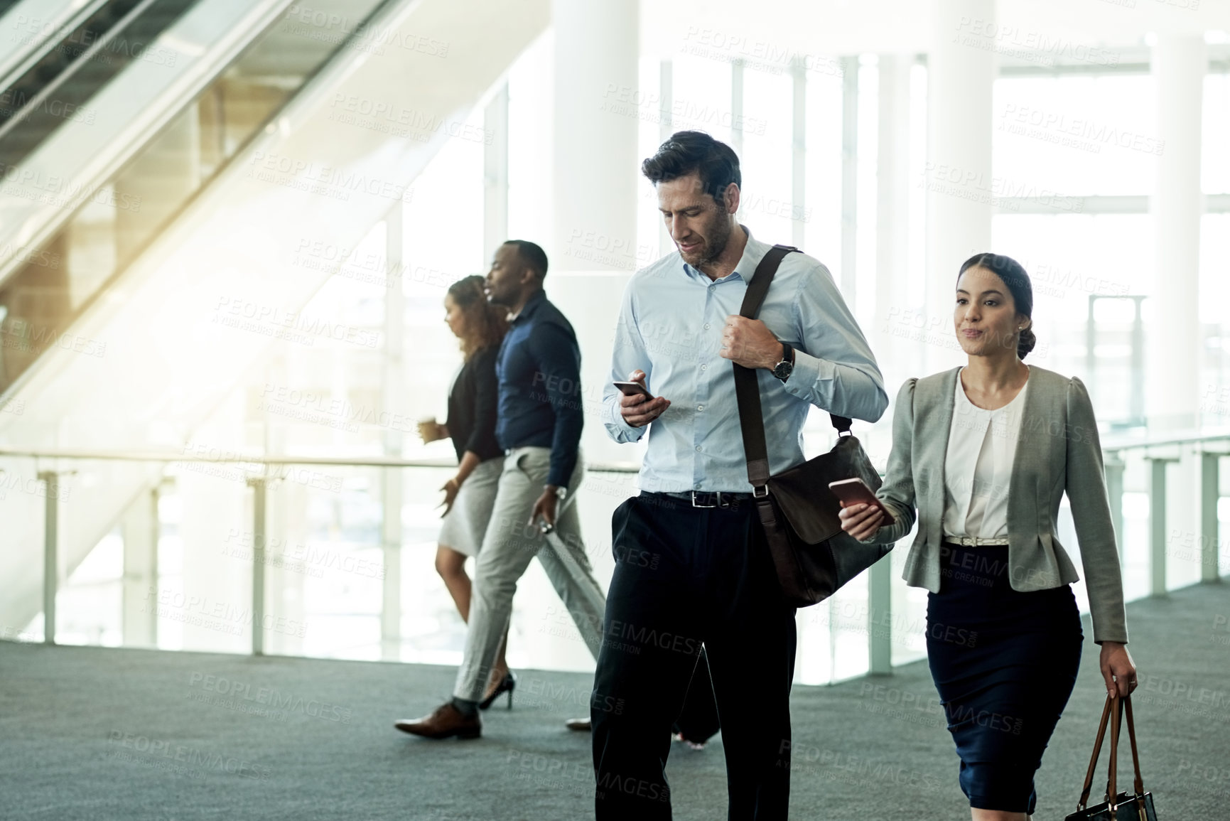 Buy stock photo Business, people and walking with phone at airport for flight schedule, booking information and airplane arrival. Professional, team and travel in lobby for corporate journey and global conference