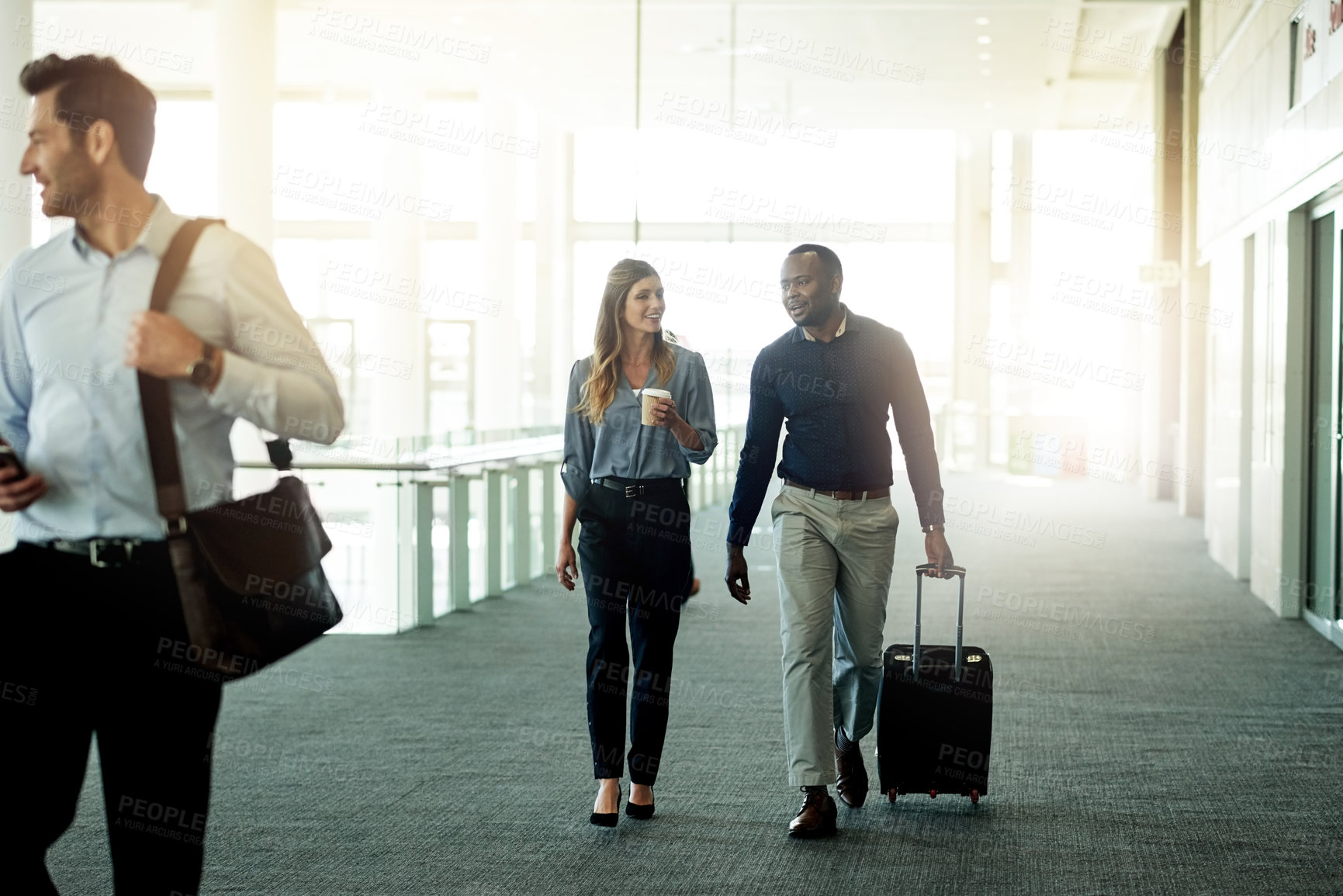 Buy stock photo Business, team and walking with luggage at airport for international trip, convention and arrival for flight. Professional, people and travel in lobby for corporate journey, conversation or departure