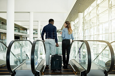 Buy stock photo Discussion, airport and business people on escalator for travel, commute and arrival in lobby. International trip, conference and man and woman with suitcase for collaboration, meeting and seminar
