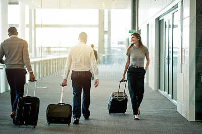 Buy stock photo Business, people and walking with luggage at airport for international trip, global expo and arriving for flight. Professional, group and travel in lobby for corporate journey and airplane departure