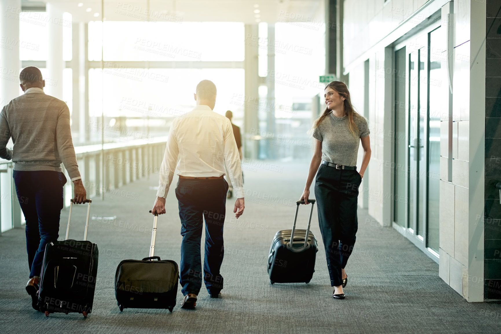 Buy stock photo Business, people and walking with luggage at airport for international trip, global expo and arriving for flight. Professional, group and travel in lobby for corporate journey and airplane departure