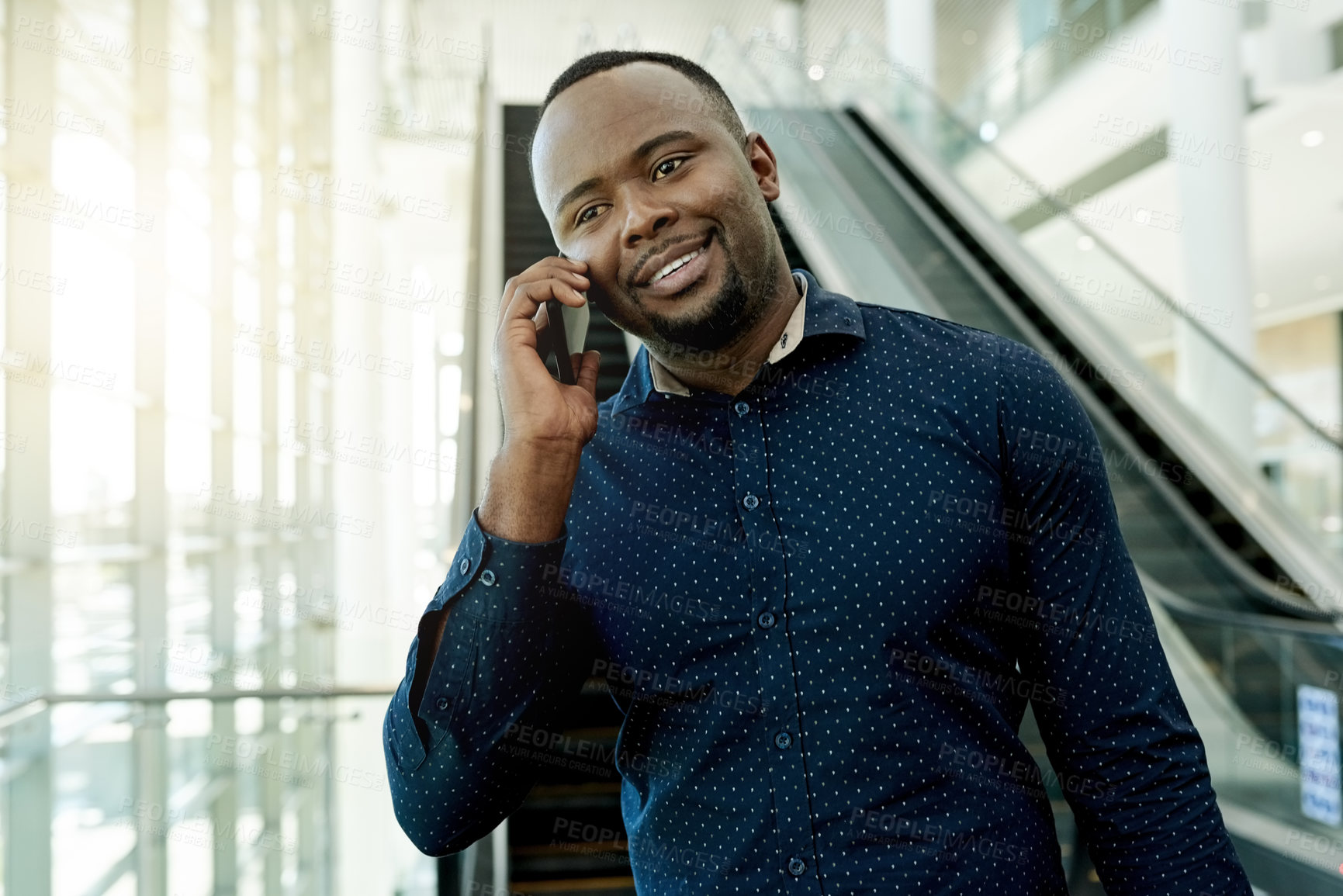 Buy stock photo Phone call, lobby and African businessman on escalator for commute, travel and arrival for conference. Professional, global worker and person in airport with smartphone for contact and networking