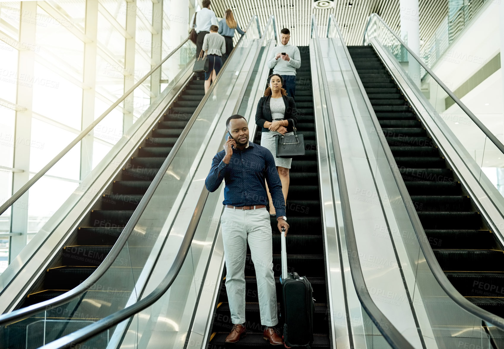 Buy stock photo Man, phone call and suitcase on escalator for travel, business contact and planning trip. Journalist, luggage and technology in airport for communication, booking accommodation and news source update