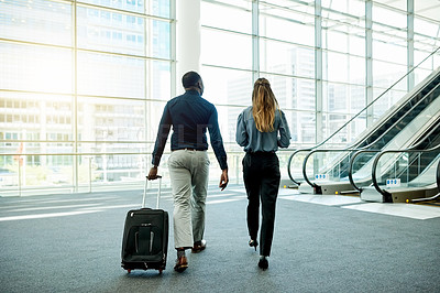 Buy stock photo Escalator, airport and business people with luggage for travel, commute and arrival in lobby. International trip, conference and man and woman with suitcase for collaboration, meeting and seminar
