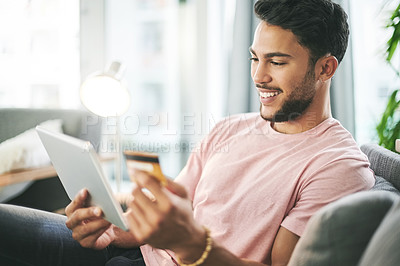 Buy stock photo Credit card, sofa and man on tablet for online shopping, internet purchase and payment in home. Ecommerce, fintech and person on digital tech for website sale, subscription sign up and banking app