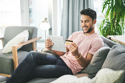 Buy stock photo Credit card, happy and man on sofa on tablet for online shopping, internet purchase and payment in home. Ecommerce, fintech and person on digital tech for website sale, subscription and banking app