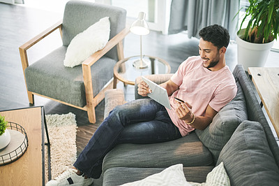 Buy stock photo Credit card, above and man on sofa on tablet for online shopping, internet purchase and payment in home. Ecommerce, fintech and person on digital tech for website sale, subscription and banking app