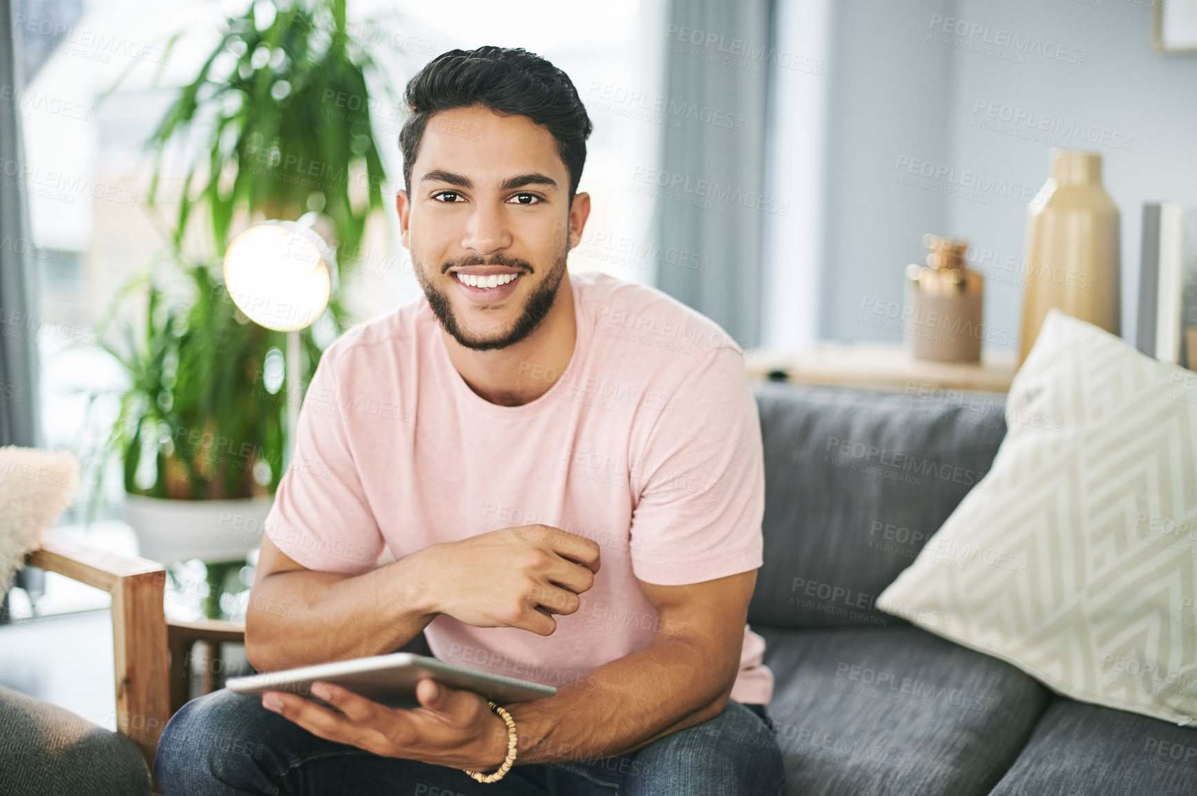 Buy stock photo Portrait, tablet and man on sofa in home with online sports chat for fan polls with match update. Happy, digital technology and male person reading tournament results on blog in living room at house.