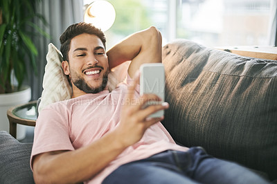 Buy stock photo Sofa, home and man with phone to relax on social media, reading internet chat and online website. Happy, living room and person chill on couch on smartphone for connection, typing message and contact