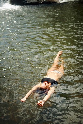 Buy stock photo Relax, woman and swimming in stream on holiday adventure with travel freedom, peaceful break or nature experience. Girl, bikini and afloat in river for weekend getaway, sightseeing or fun summer trip