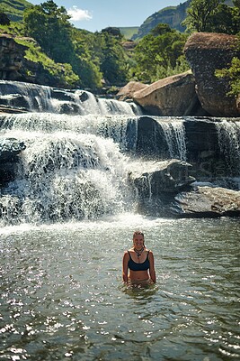 Buy stock photo Waterfall, mountain and portrait of woman in river for adventure at travel destination outdoors. Swimmer, journey and person relax in water, dam and nature stream for holiday, vacation and tourism